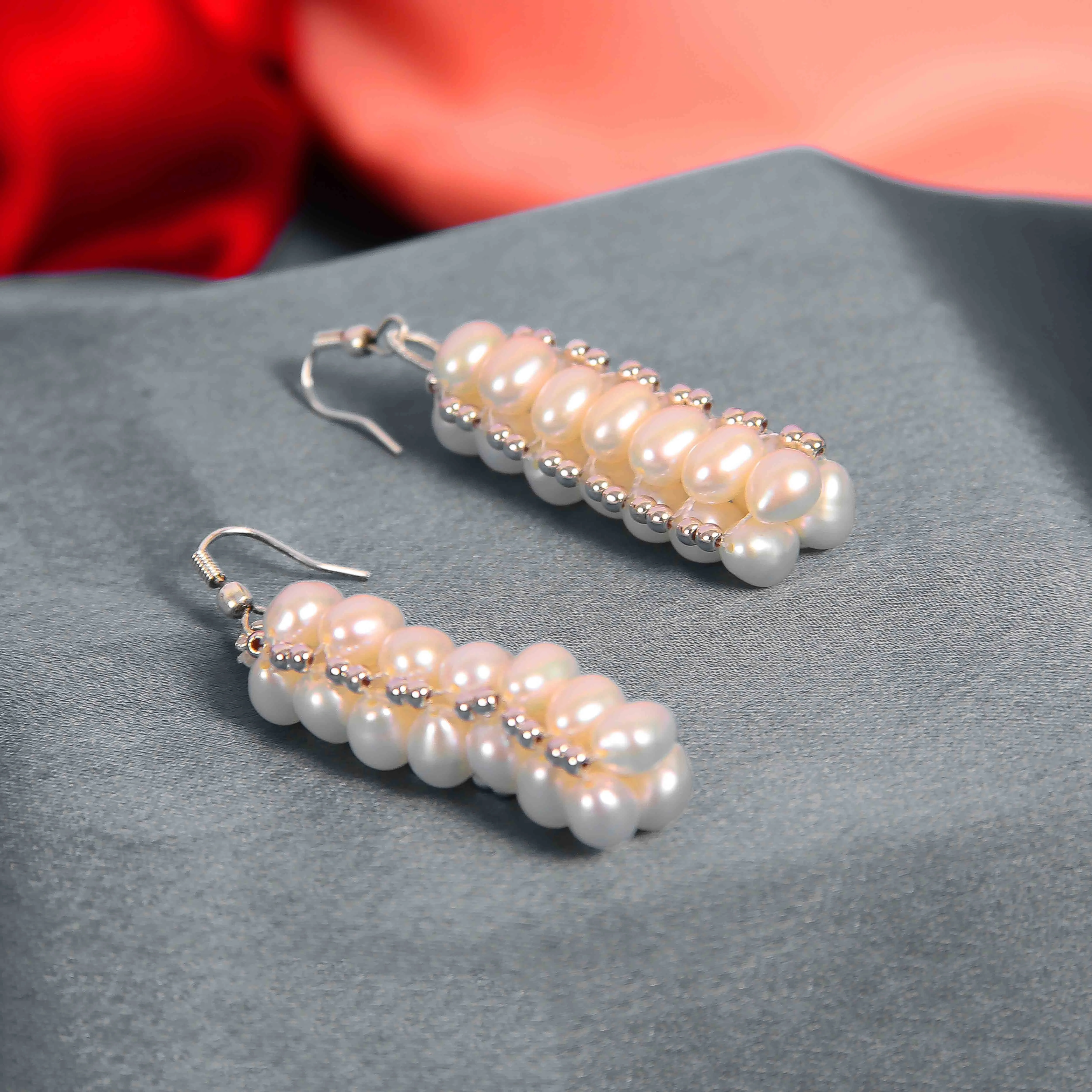 Single strand cream white pearl necklace set with silver tone beads