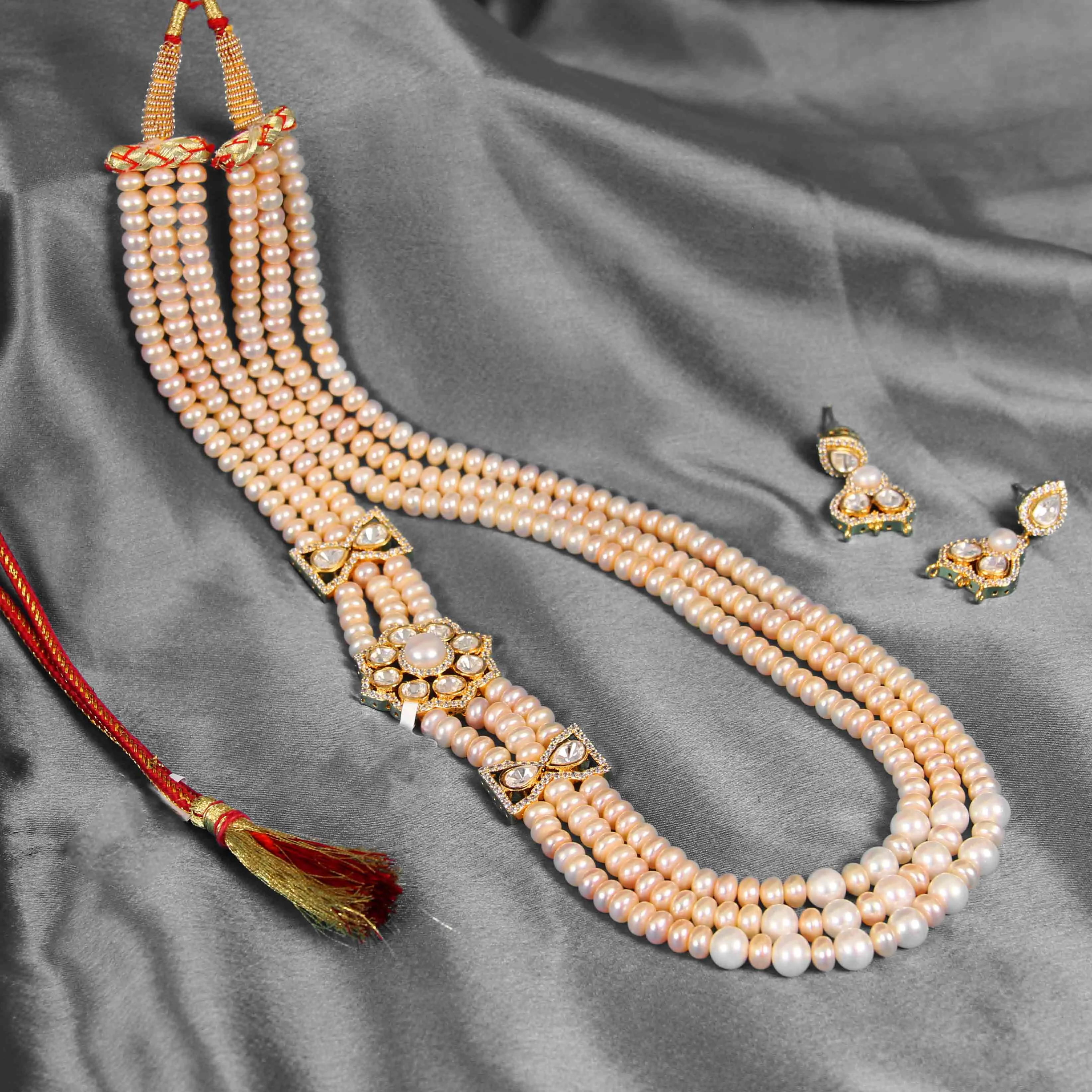 Peach ivory imitation pearl necklace and earring set with gold accents