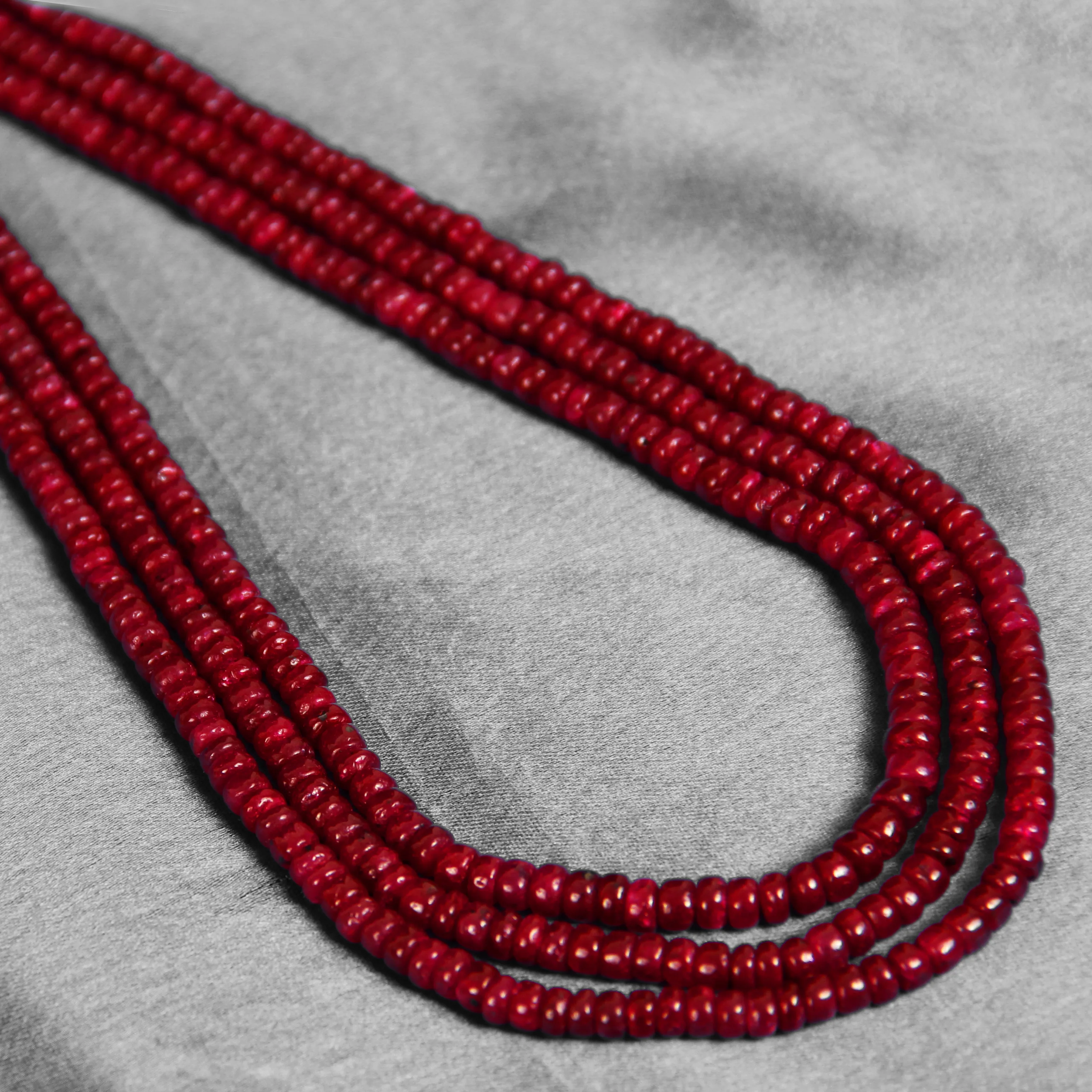 Red beaded multi-strand necklace with colorful thread