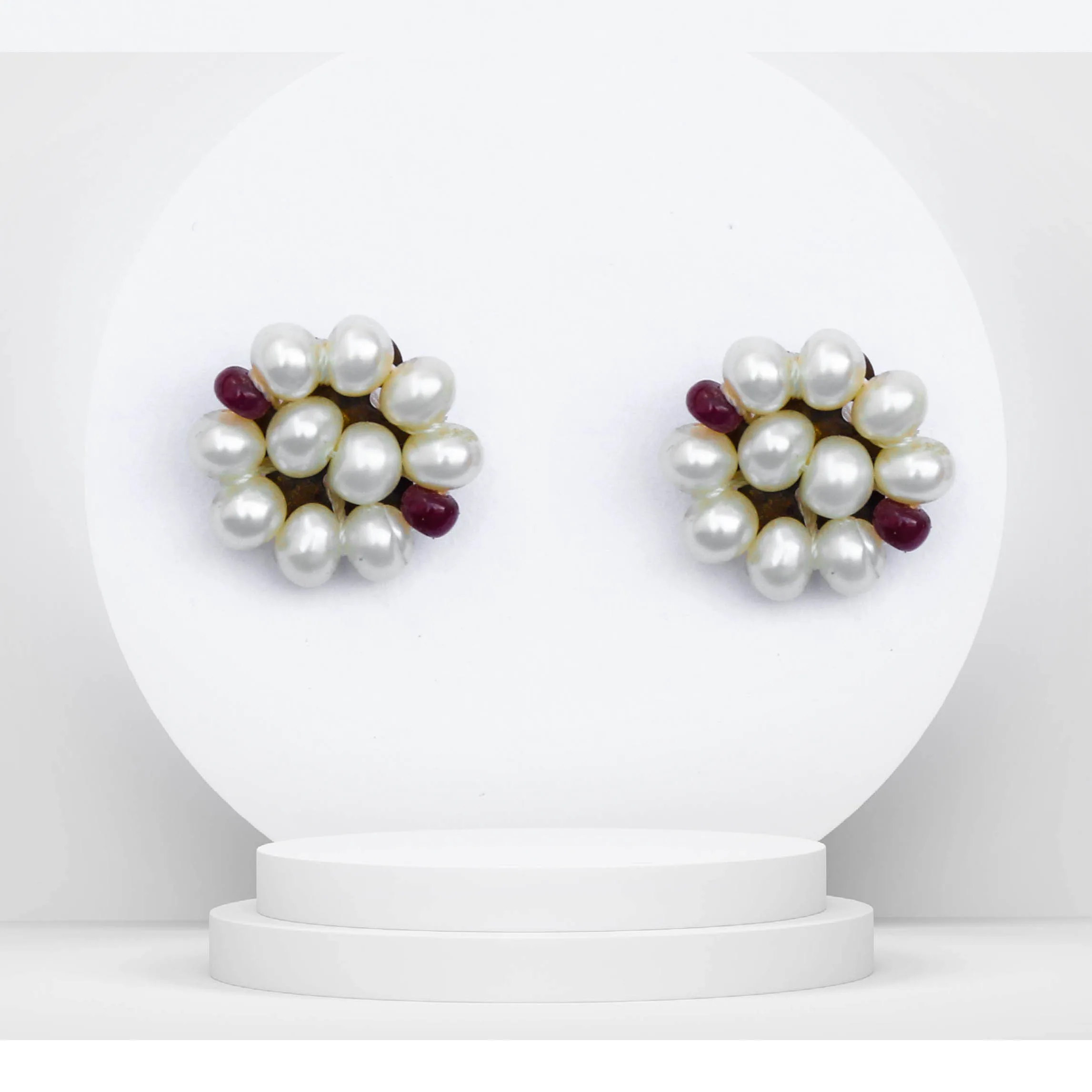 Pearl stud earrings with ruby accents, gold tone