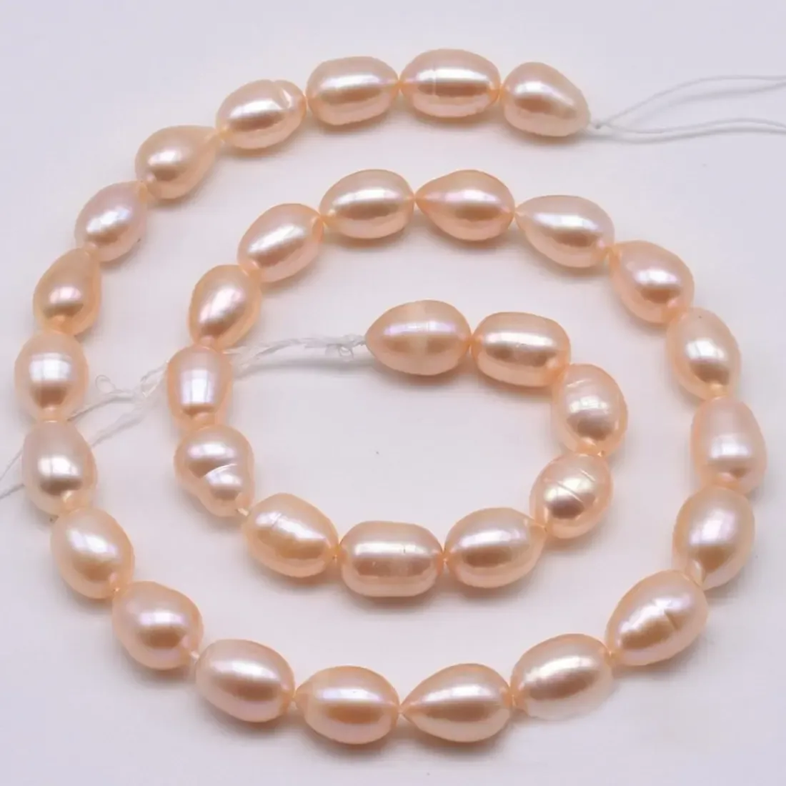 Peach pink oval rice imitation pearl bead strand 8 x 6 mm, 16 inch