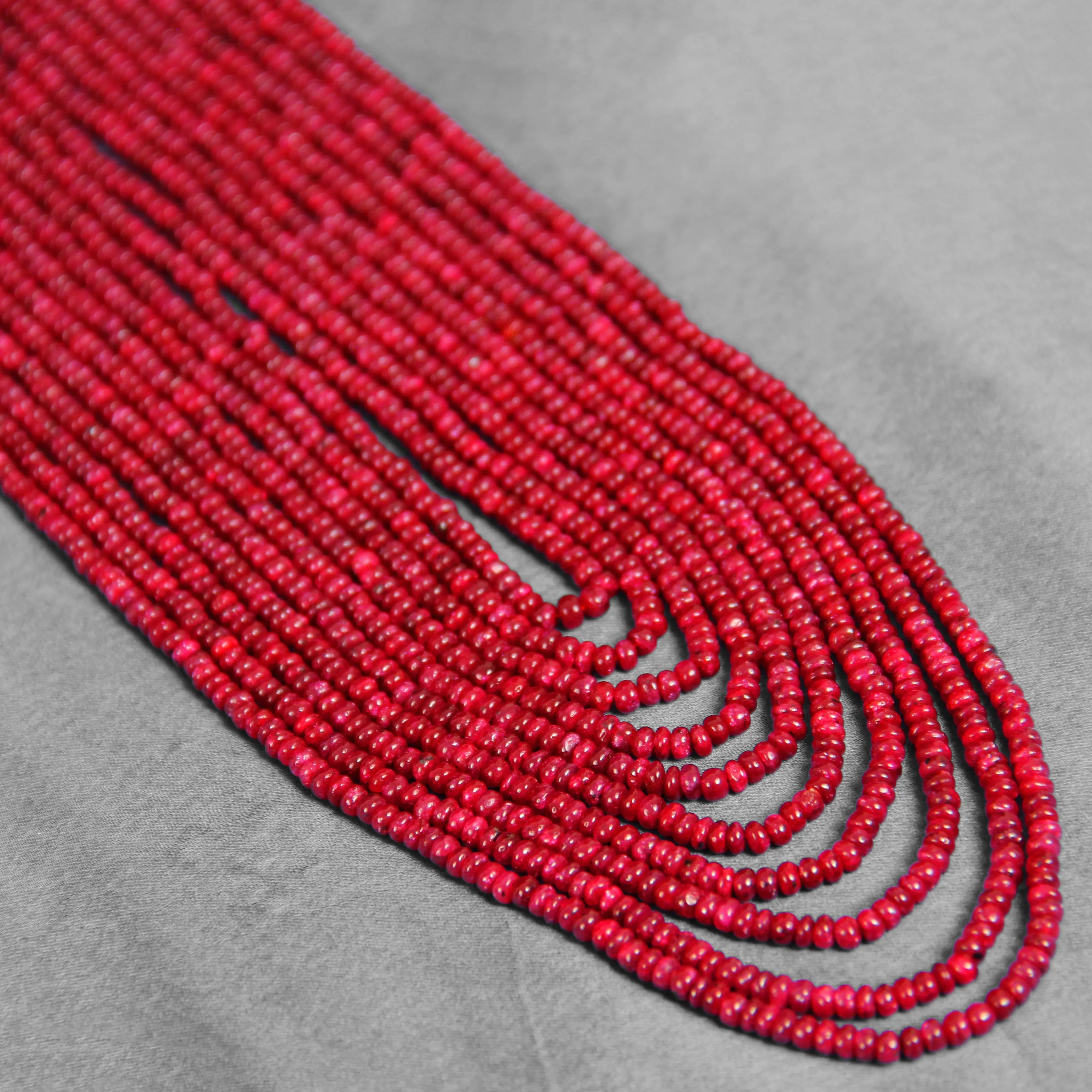 Red multi-strand beaded necklace with colorful thread